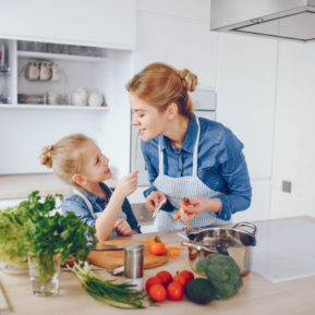 Woman and child preparing healthy food together