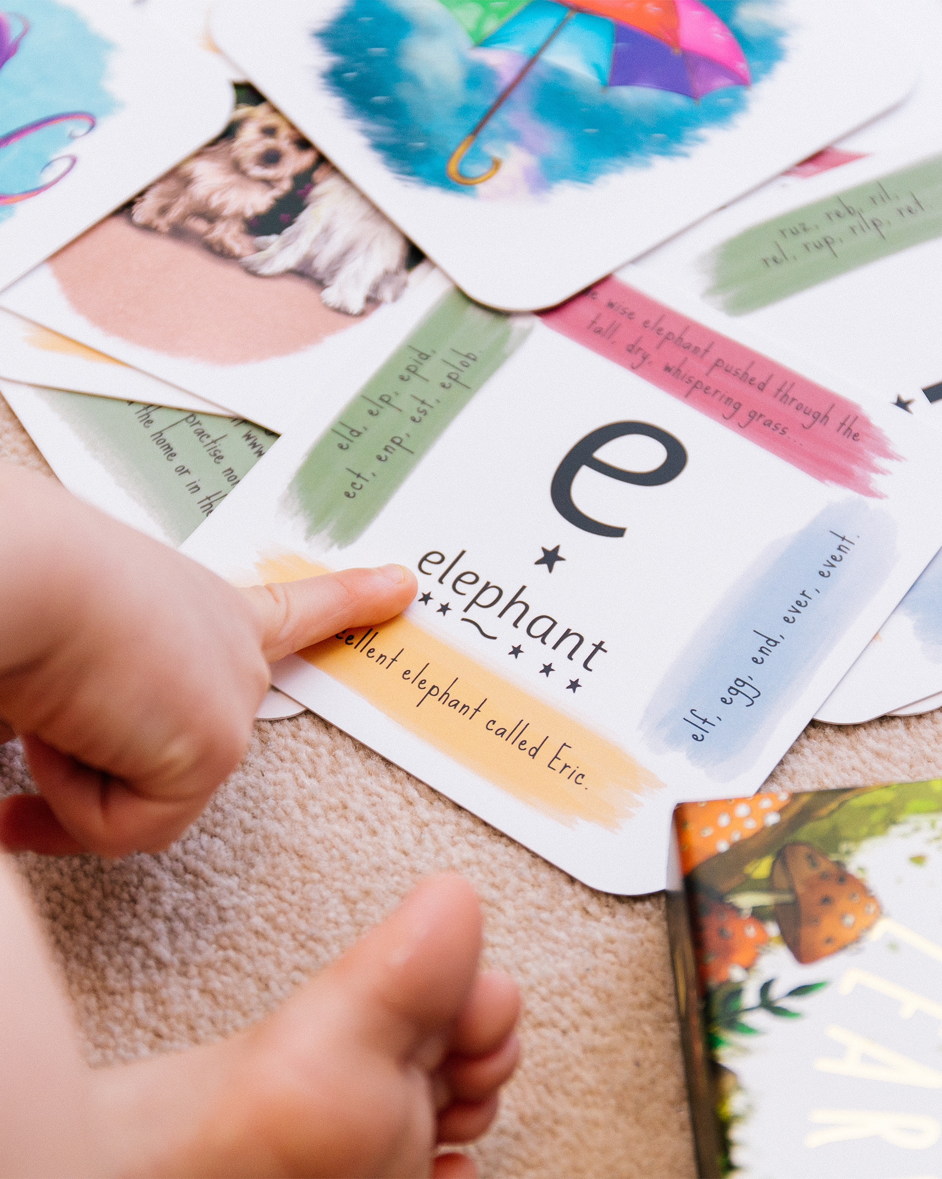 finger pointing to key sound on phonic card.