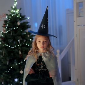 child having a tantrum in front of Christmas tree