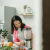 Woman in kitchen using a food processor
