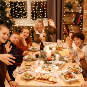 Family sitting round the dinner table at Christmas time