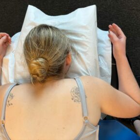 woman lying face down on a massage bed