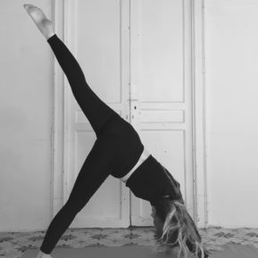 Woman practicing yoga with one leg in the air