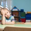 Child sat alone in classroom looking sad