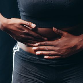 woman's hands over her stomach