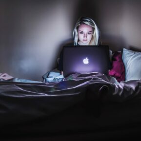 woman in the dark on laptop