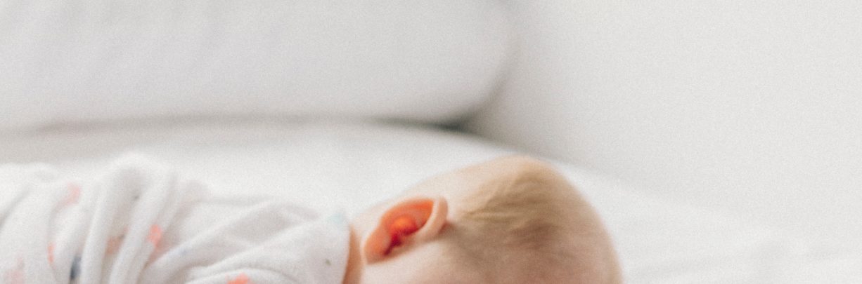 What should I do if my baby rolls onto their front in their sleep?