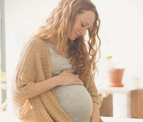 pregnant woman cradling bump