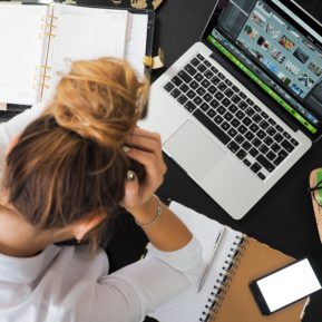 Woman in front of laptop getting stressed