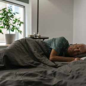 Elderly Man Sleeping on a bed