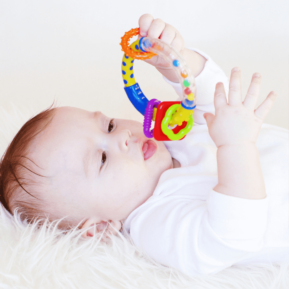 baby playing with a rattle