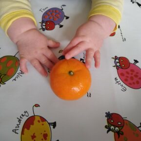 toddler with clementine